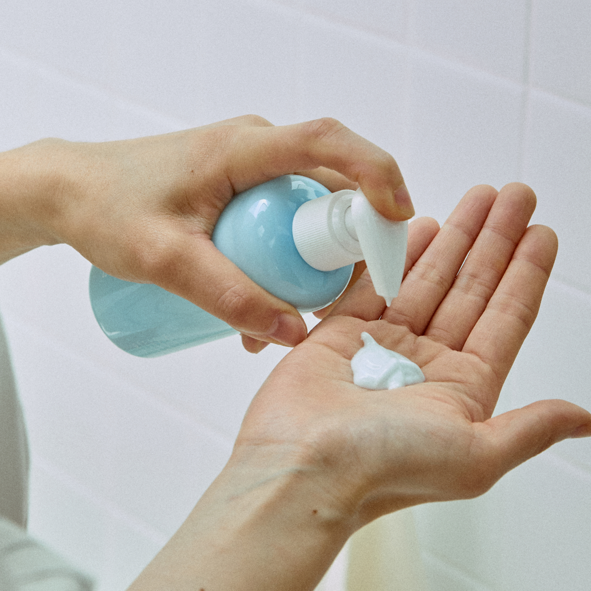 Blue Calming Cleansing Milk dispensado en la palma de una mano